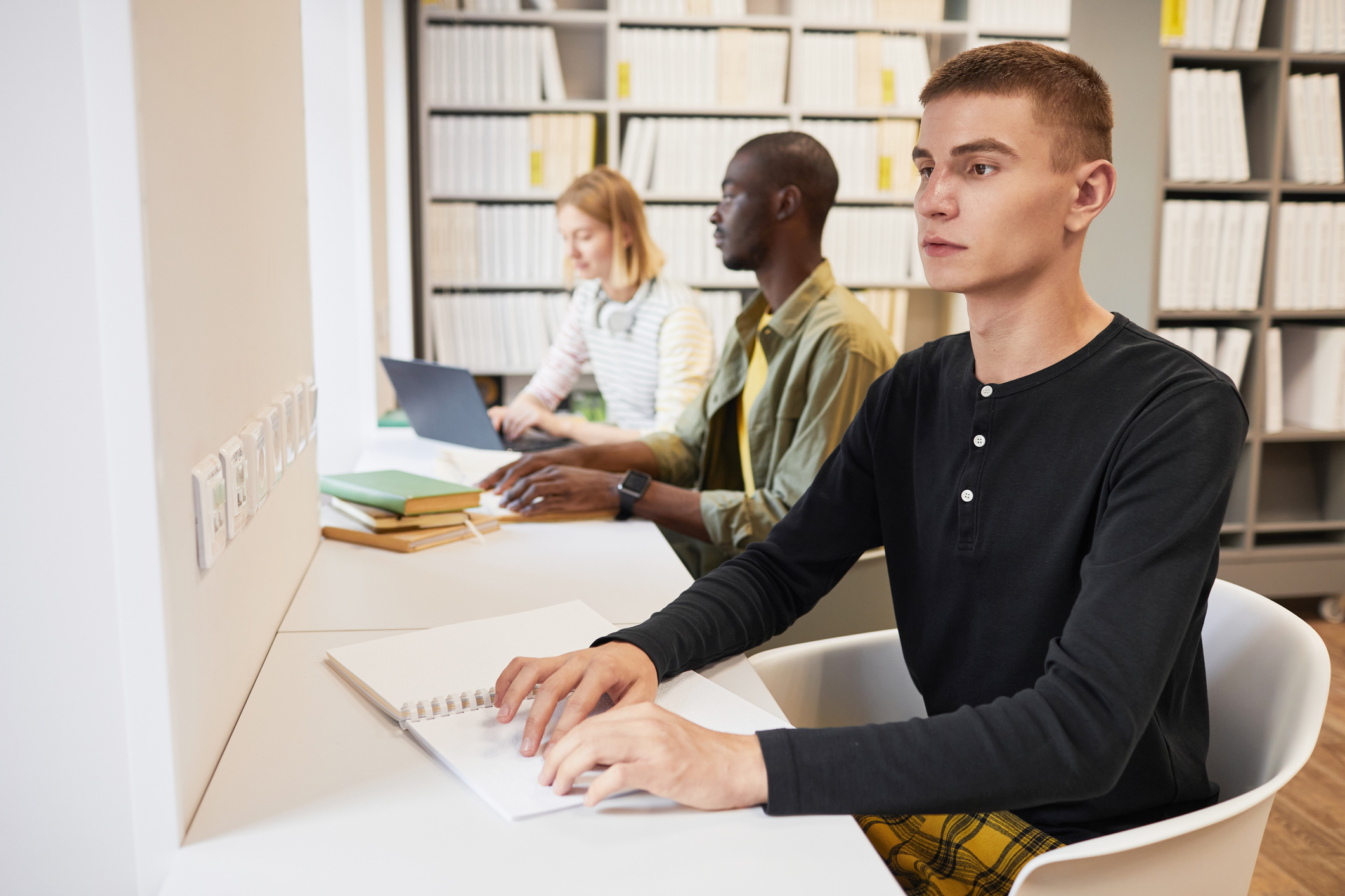 Student with blindness working in Library