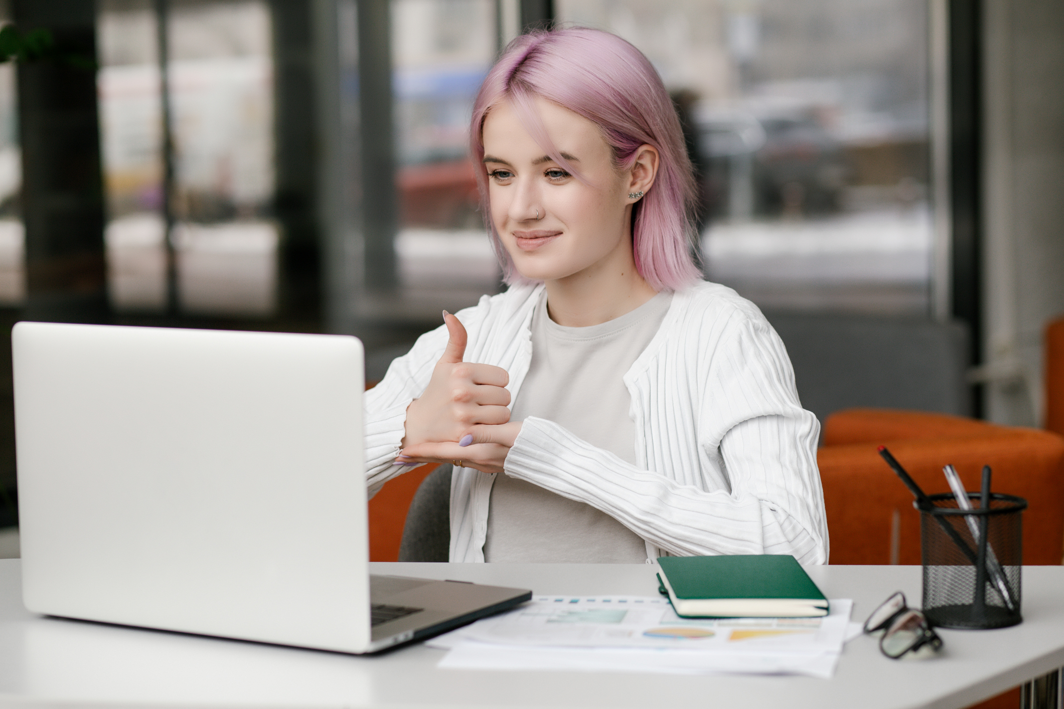 Young deaf businesswoman have digital virtual online conference with employees on computer, talking on video call