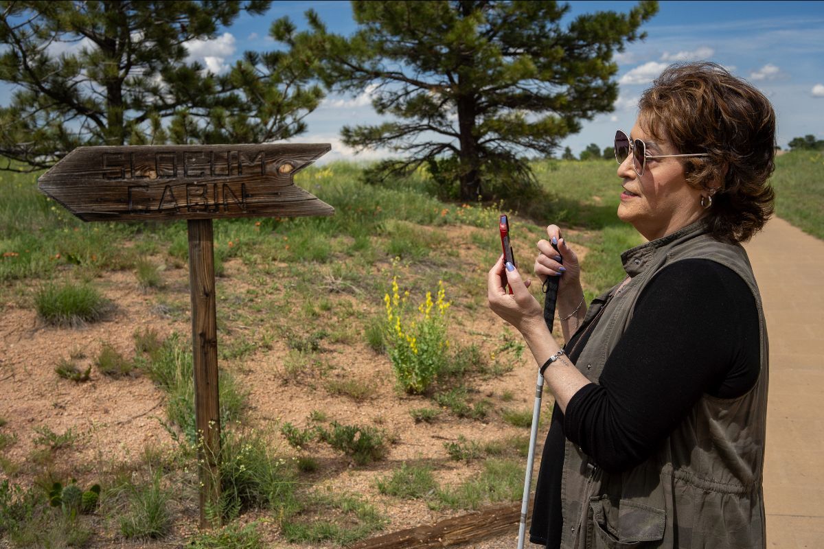 Theresa Montano uses the Aira app on a trail at Chatfield State Park