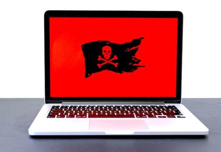 Graphic of a black pirate flag with a red background on a laptop screen