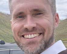 Sean Clark standing outside smiling.