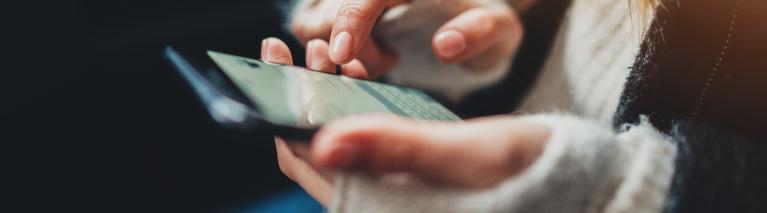 Closeup of someone holding and scrolling on their smartphone